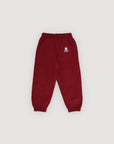 Maroon sweatpants with a logo on a light gray background