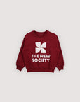 Red sweatshirt with 'The New Society' logo on a light gray background